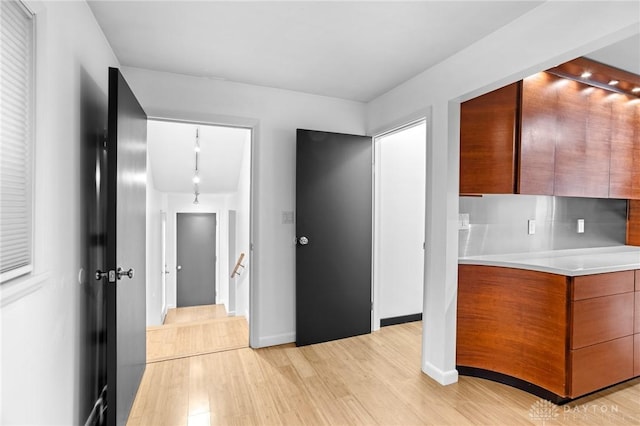 kitchen featuring light wood-type flooring and rail lighting