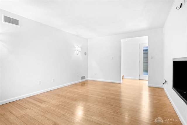 unfurnished living room featuring light hardwood / wood-style floors