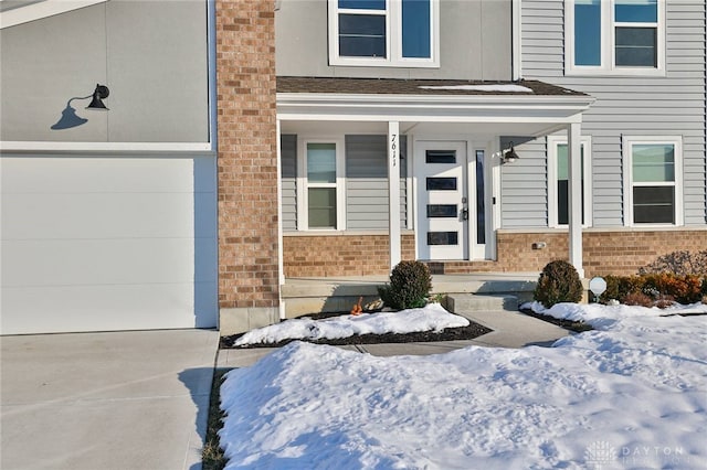 view of snow covered property entrance