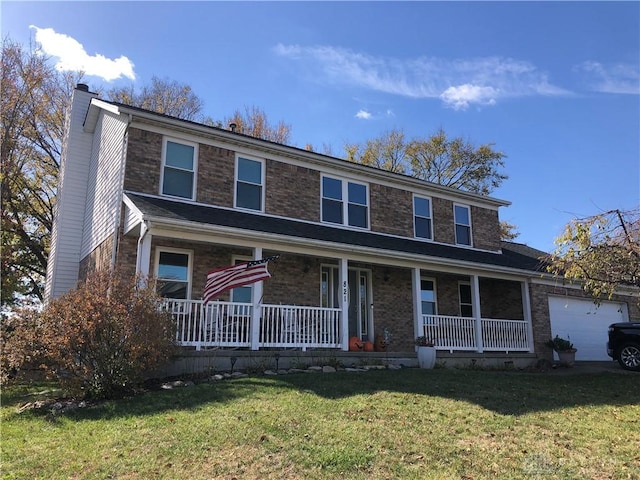 view of front of home with a garage, a front lawn, and a porch