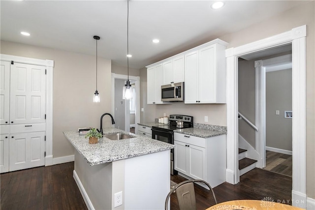 kitchen with decorative light fixtures, white cabinets, and stainless steel appliances