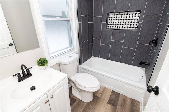 full bathroom with toilet, tiled shower / bath combo, vanity, and hardwood / wood-style flooring