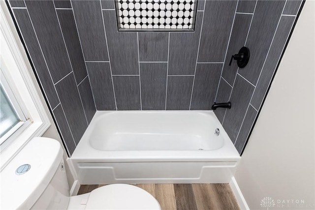 bathroom featuring hardwood / wood-style floors, toilet, and  shower combination