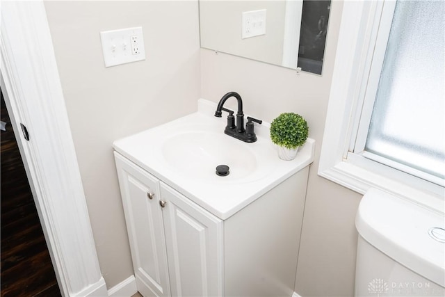 bathroom with toilet and vanity