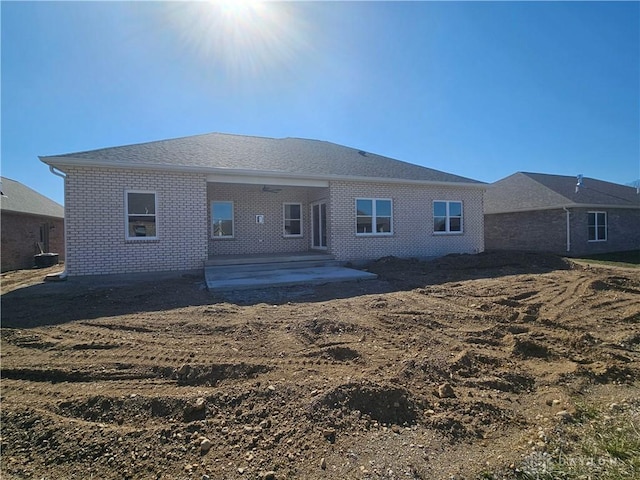 rear view of house with a patio area and brick siding