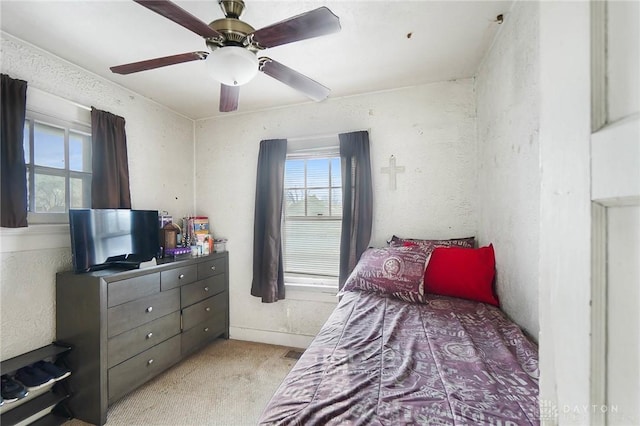 bedroom with ceiling fan and light colored carpet