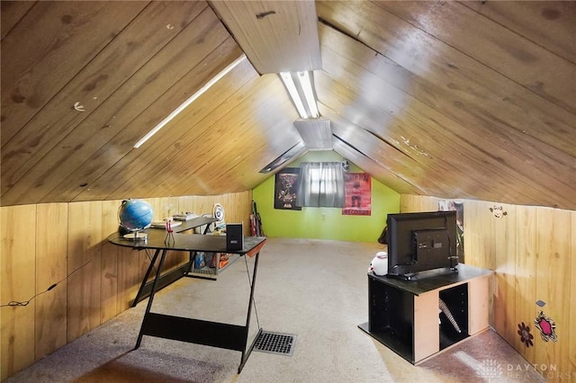 carpeted home office featuring vaulted ceiling, wood ceiling, and wooden walls