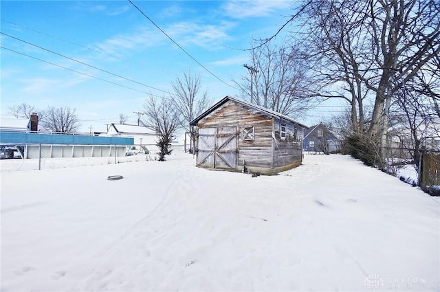 yard covered in snow with an outdoor structure