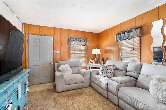 living room featuring light carpet and wood walls