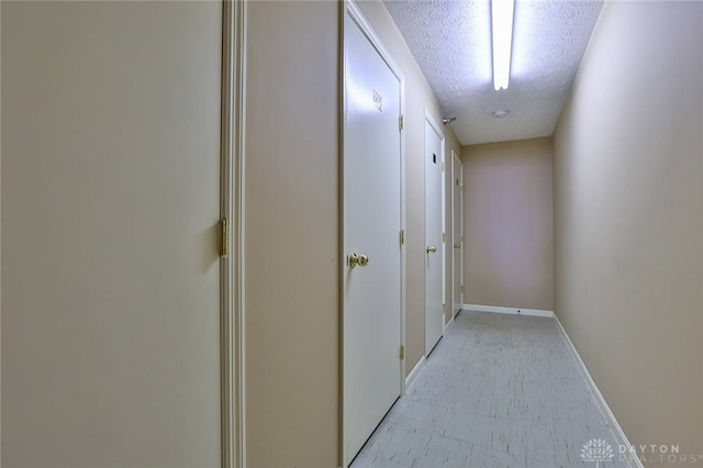 corridor with a textured ceiling