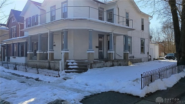 view of snow covered exterior featuring covered porch