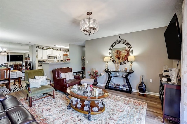 living room with hardwood / wood-style flooring and a chandelier