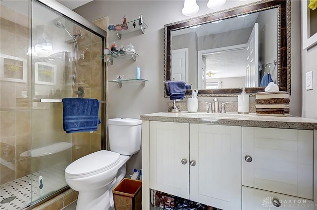 bathroom with toilet, walk in shower, and vanity