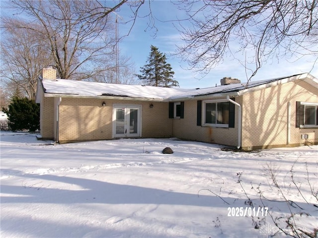 snow covered property with french doors