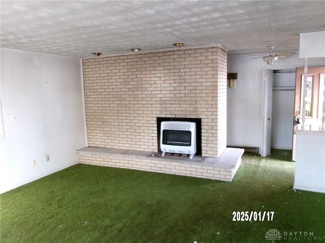 unfurnished living room featuring heating unit, baseboard heating, carpet, and a textured ceiling