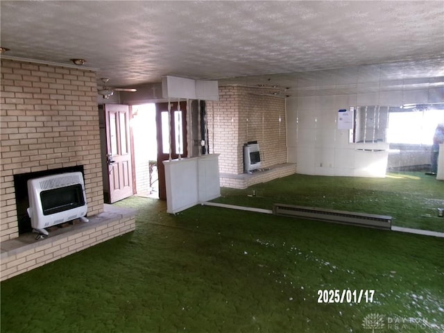 unfurnished living room with heating unit, baseboard heating, and a textured ceiling