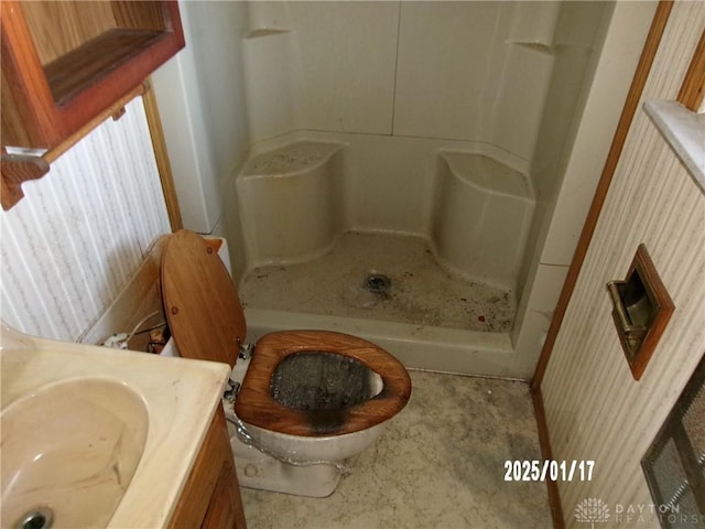 bathroom featuring walk in shower, vanity, and toilet