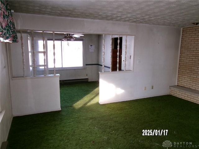 carpeted spare room with a textured ceiling, ceiling fan, and a baseboard radiator