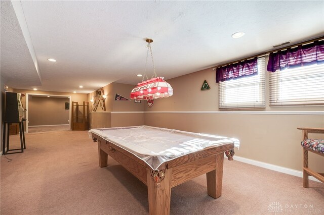 game room with a textured ceiling, billiards, and light carpet