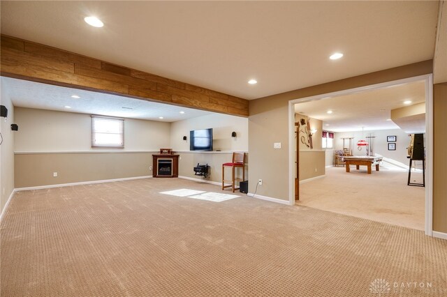 basement with pool table and light colored carpet