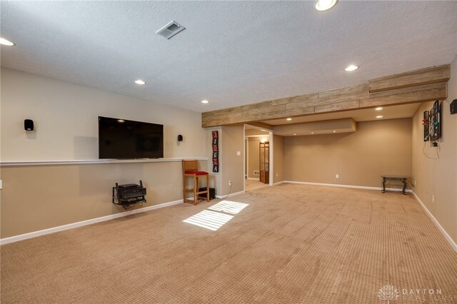 basement with light colored carpet and a textured ceiling