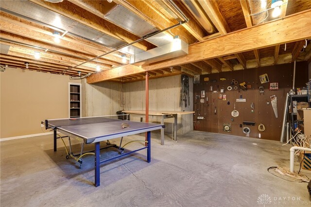 playroom with a workshop area and concrete flooring