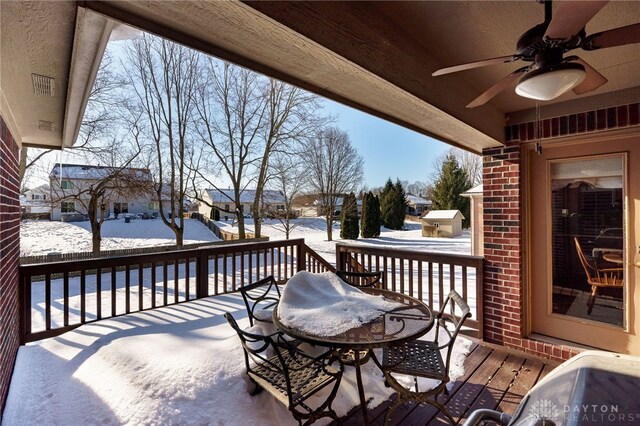 snow covered deck featuring ceiling fan