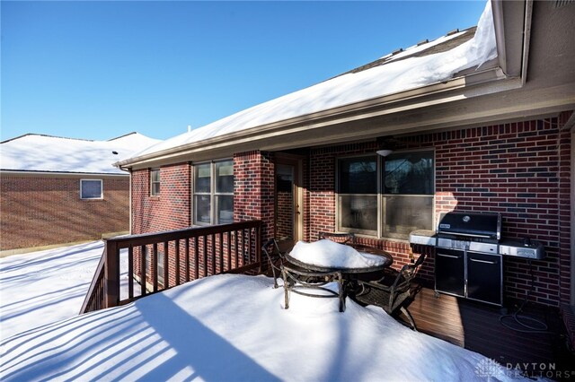 snow covered deck with grilling area