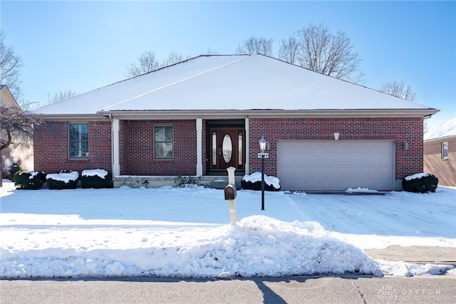 single story home featuring a garage and brick siding