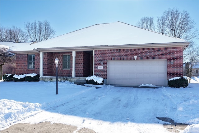 ranch-style house featuring an attached garage and brick siding