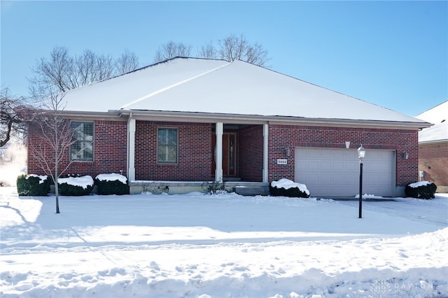 single story home with a garage and brick siding