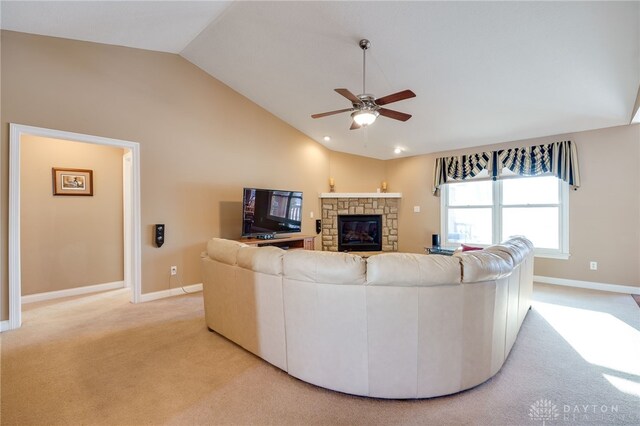 carpeted living room featuring ceiling fan, a fireplace, and vaulted ceiling