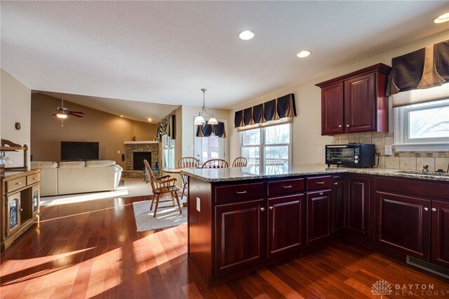 kitchen featuring backsplash, pendant lighting, and dark hardwood / wood-style flooring