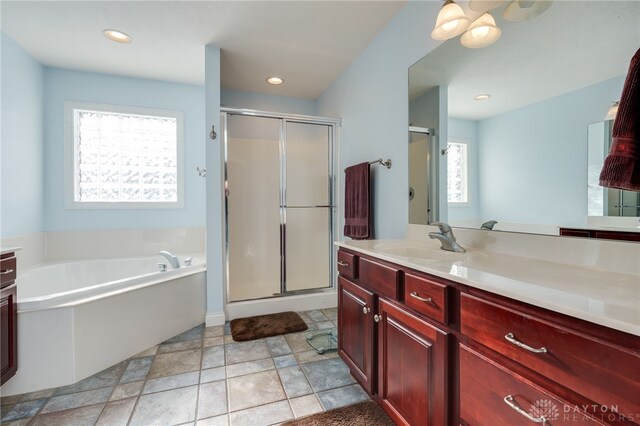 bathroom featuring vanity and separate shower and tub