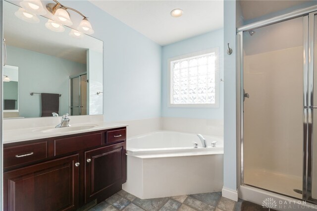 bathroom featuring separate shower and tub and vanity