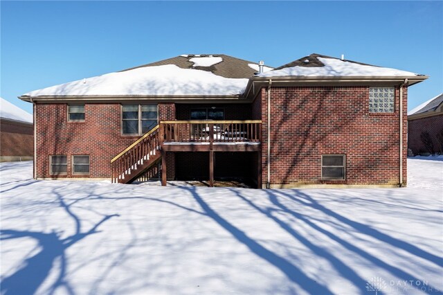 snow covered property featuring a deck