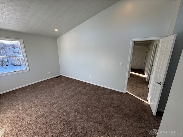 unfurnished room with a textured ceiling, recessed lighting, dark carpet, and baseboards