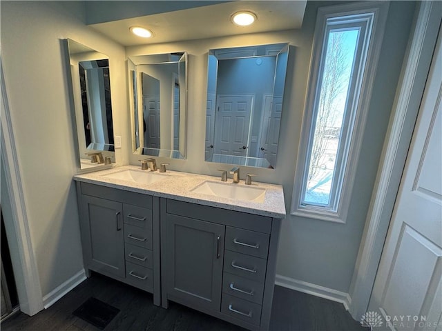 bathroom featuring plenty of natural light, a sink, and visible vents