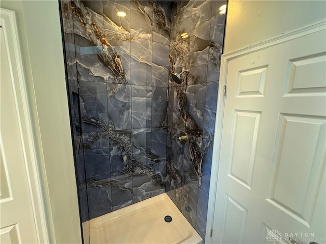 bathroom with a marble finish shower