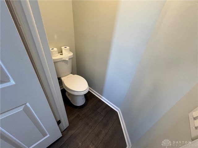 bathroom featuring baseboards, toilet, and wood finished floors