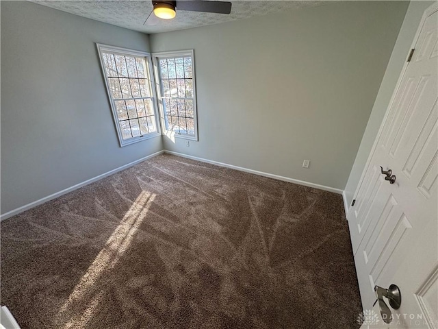 unfurnished bedroom featuring a ceiling fan, baseboards, a textured ceiling, and carpet flooring