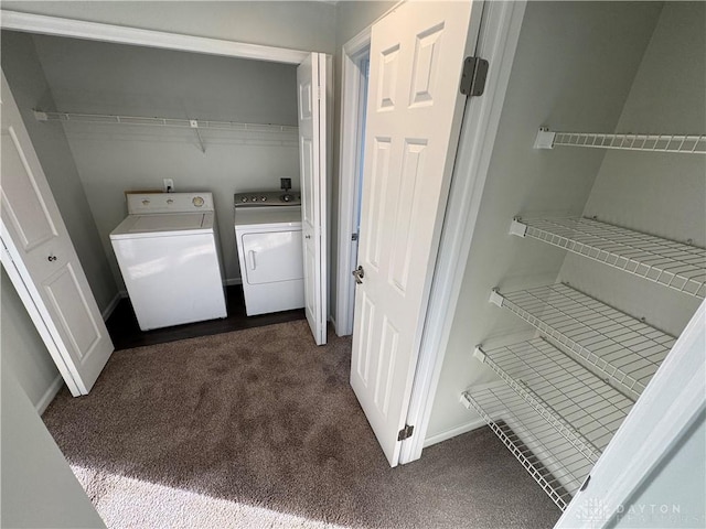 washroom featuring laundry area, independent washer and dryer, dark carpet, and baseboards