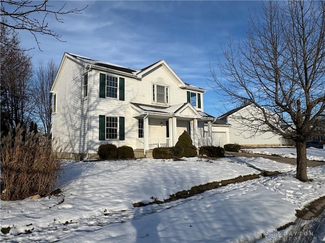 view of front facade with a garage and covered porch