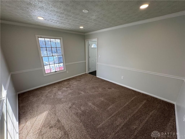 carpeted spare room featuring ornamental molding, recessed lighting, a textured ceiling, and baseboards