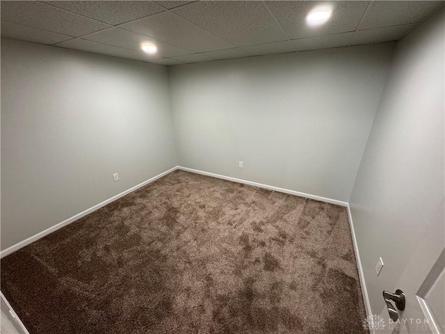 spare room with carpet floors, baseboards, and a paneled ceiling