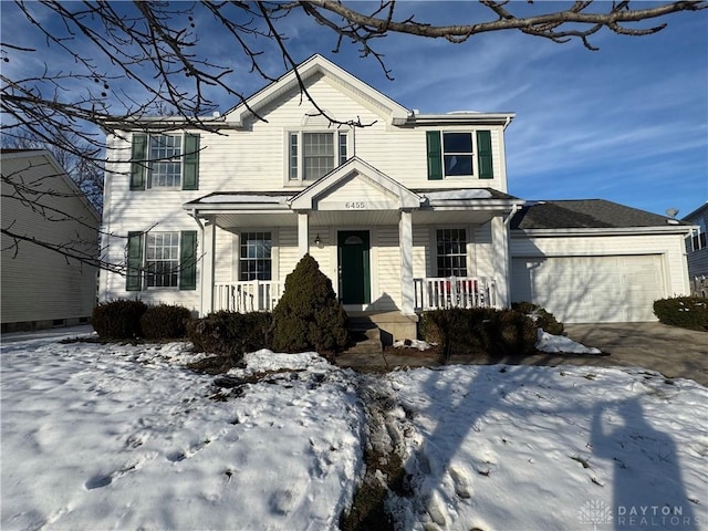 view of front facade featuring covered porch, driveway, and an attached garage