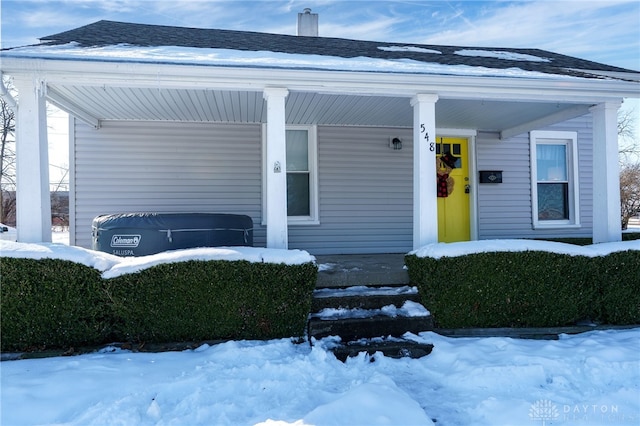 view of snow covered property entrance