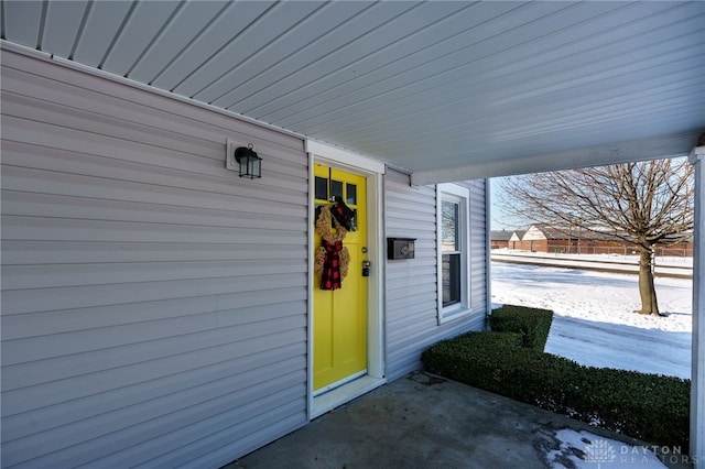 view of snow covered property entrance