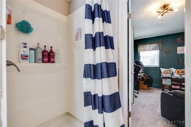 bathroom with a shower with curtain and a textured ceiling