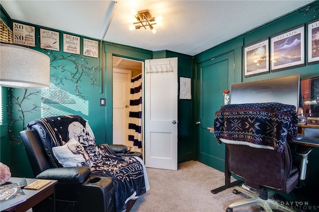 bedroom with light colored carpet and a textured ceiling